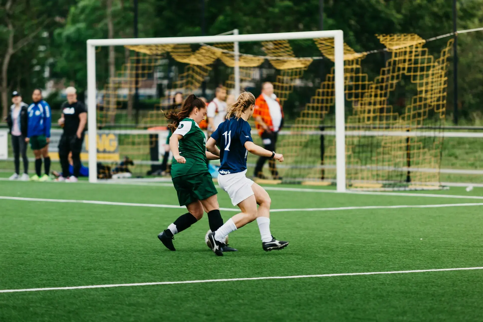 Soccer players competing on turf field