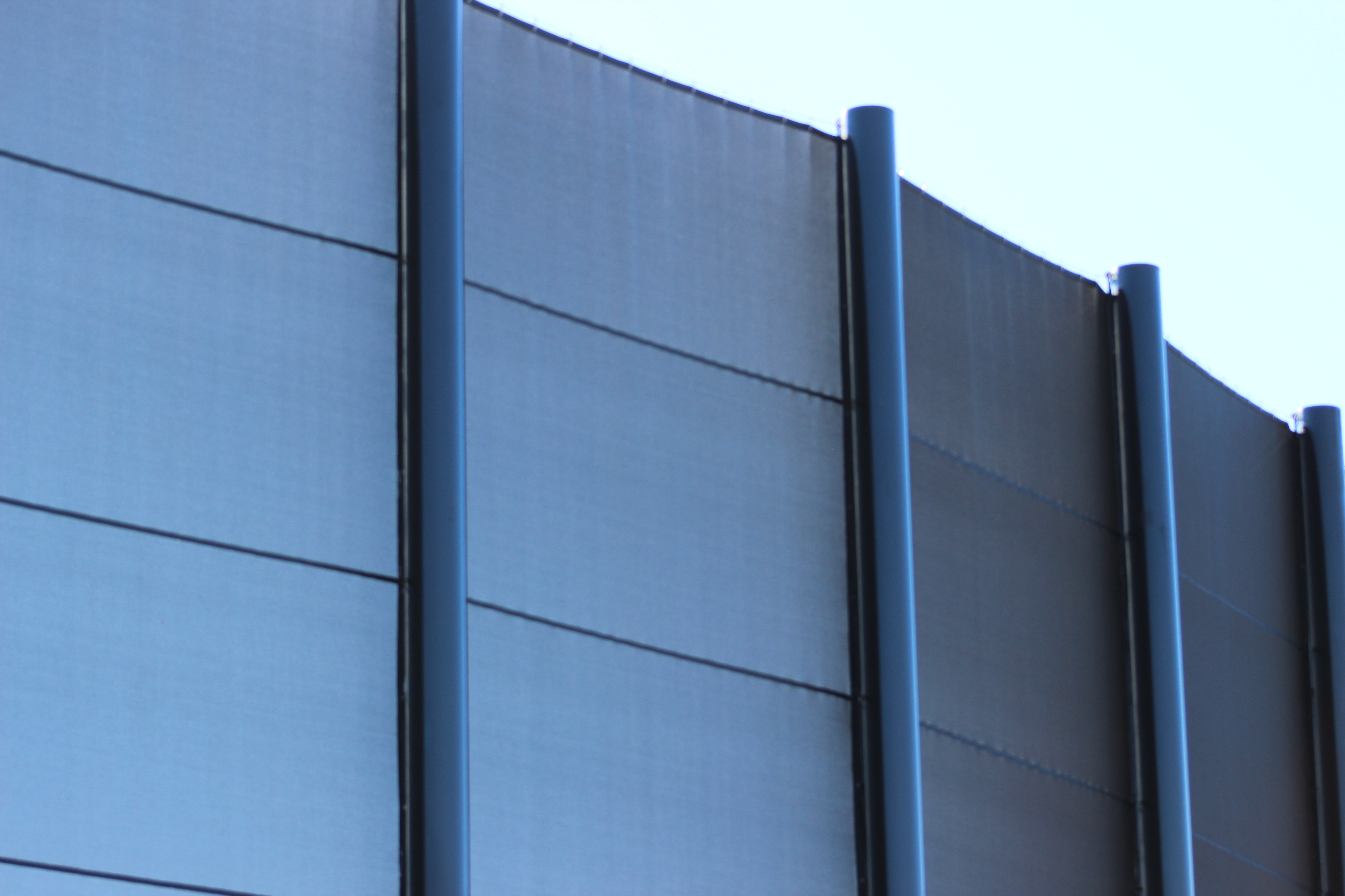 Batter's eye screen mesh panel detail showing aluminum posts
