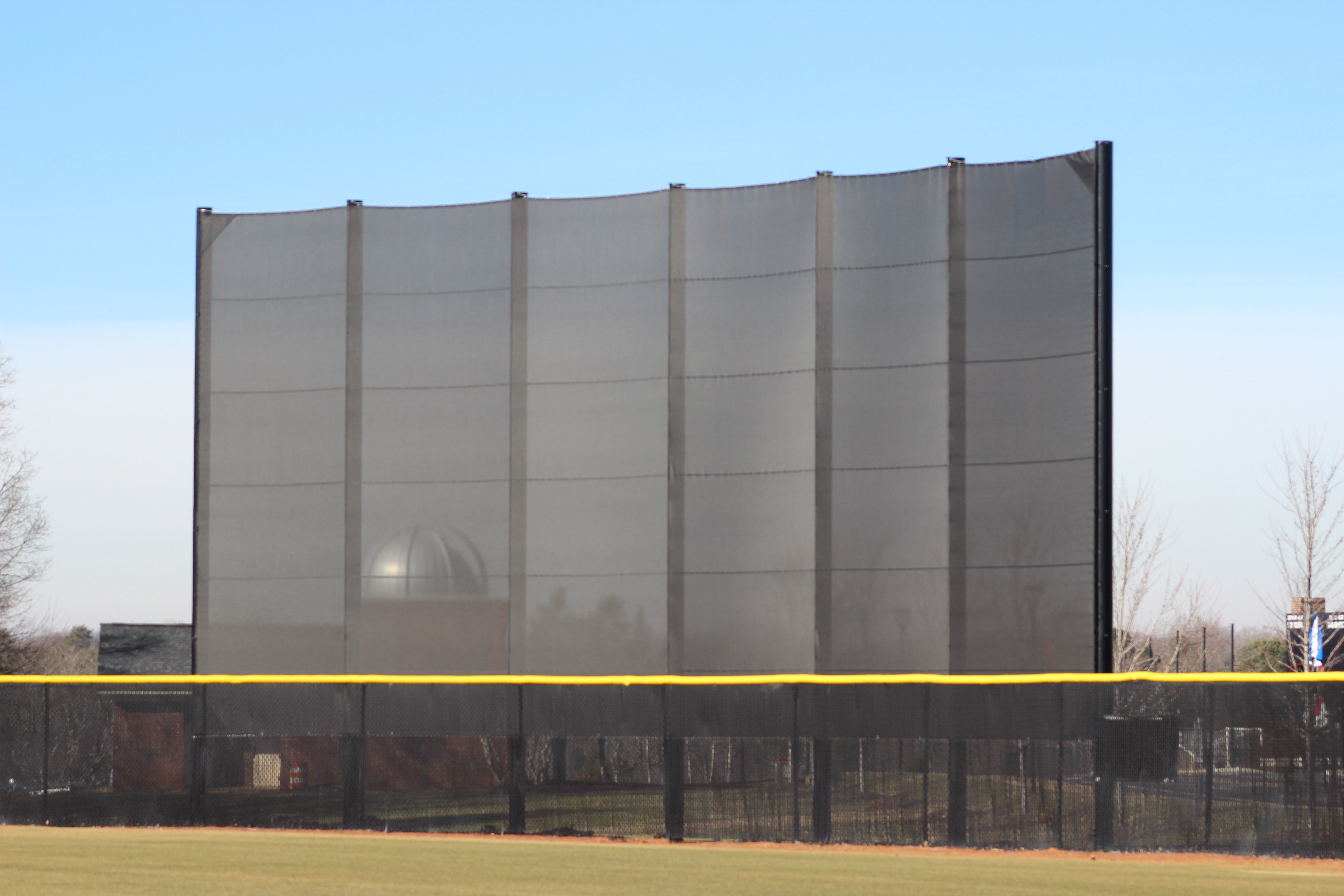 Batter's eye screen installed at baseball field with aluminum frame and mesh panels